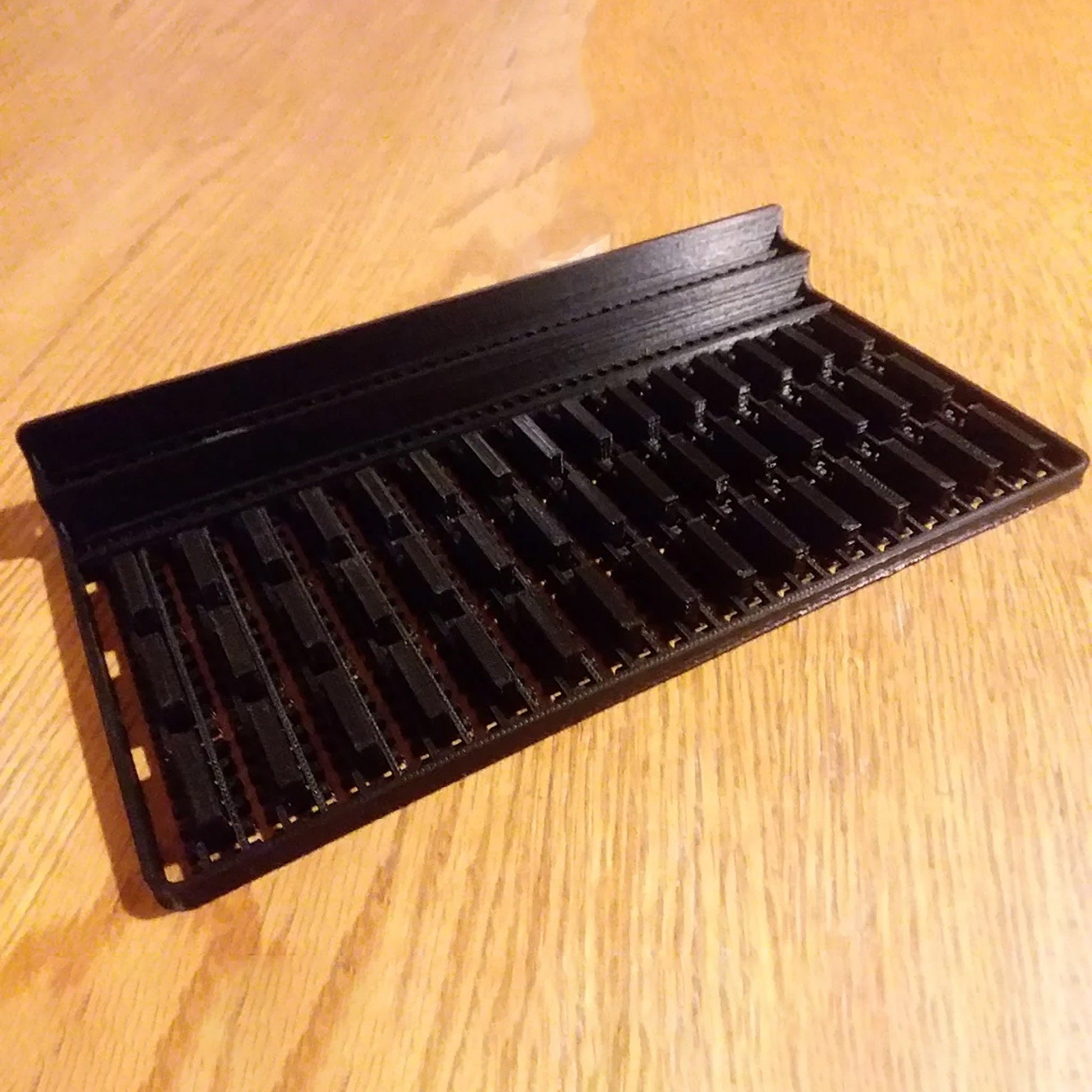 a black shelf sitting on top of a wooden table