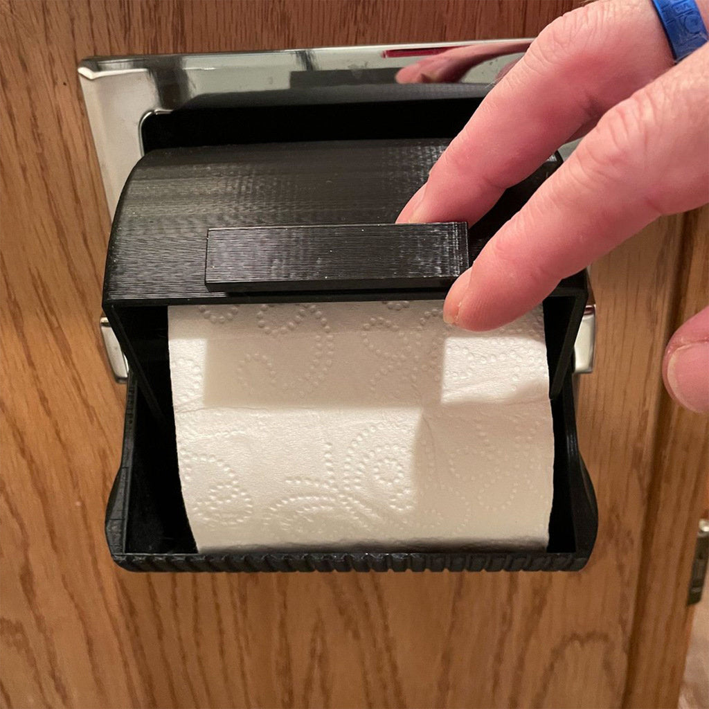 Rounded toilet paper roll cover on a wall holder protecting the roll from splashes, view 2