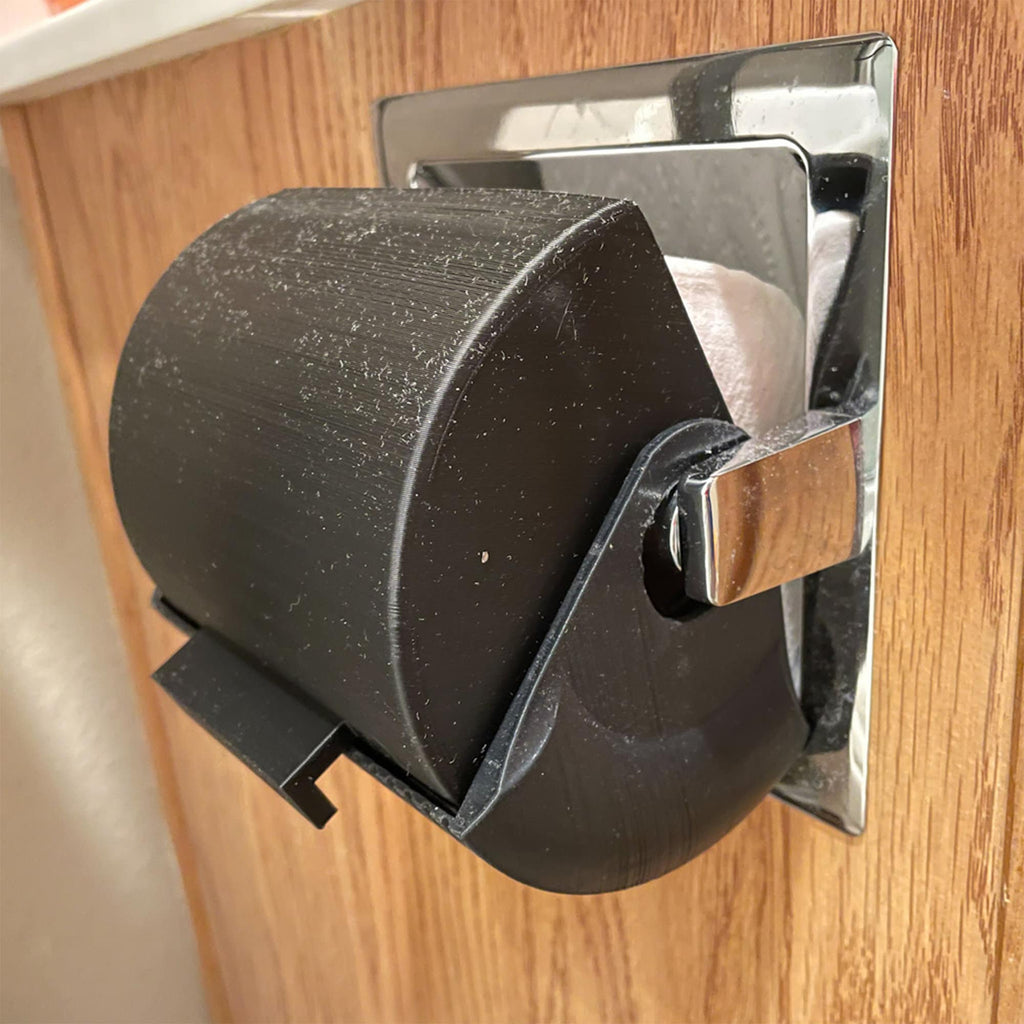 Rounded toilet paper roll cover on a wall holder protecting the roll from splashes