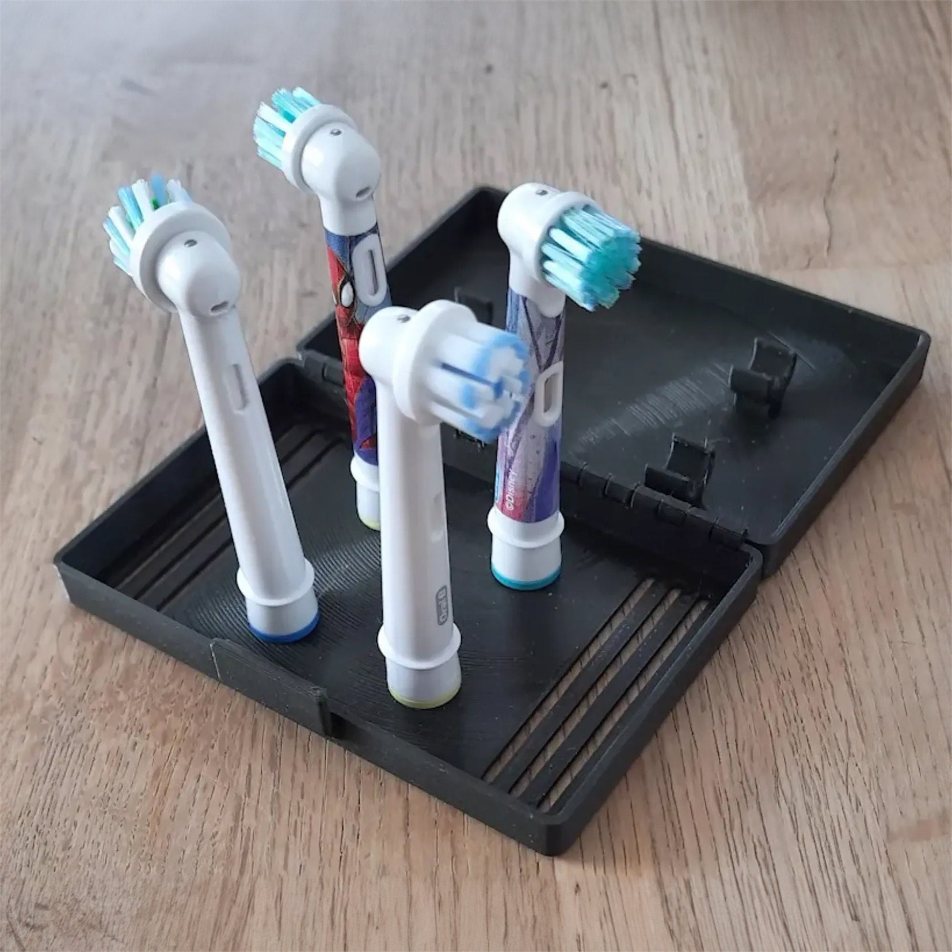 three toothbrushes sitting on a tray on a table