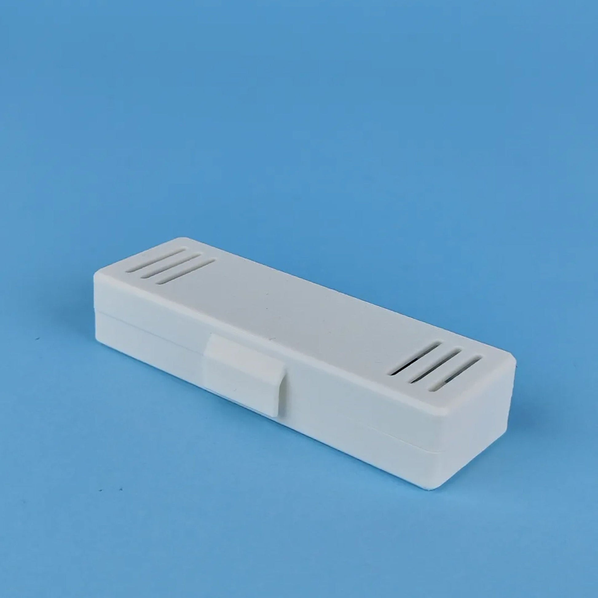 a white plastic object on a blue background