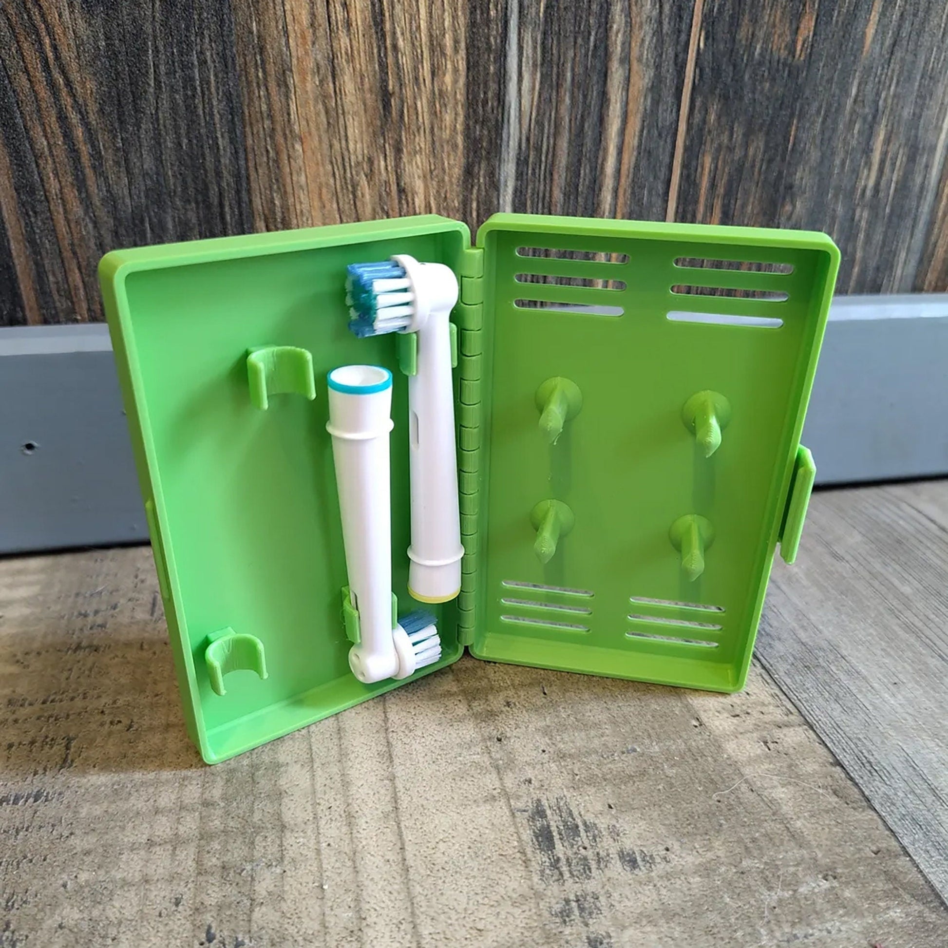 a green box with two toothbrushes inside of it