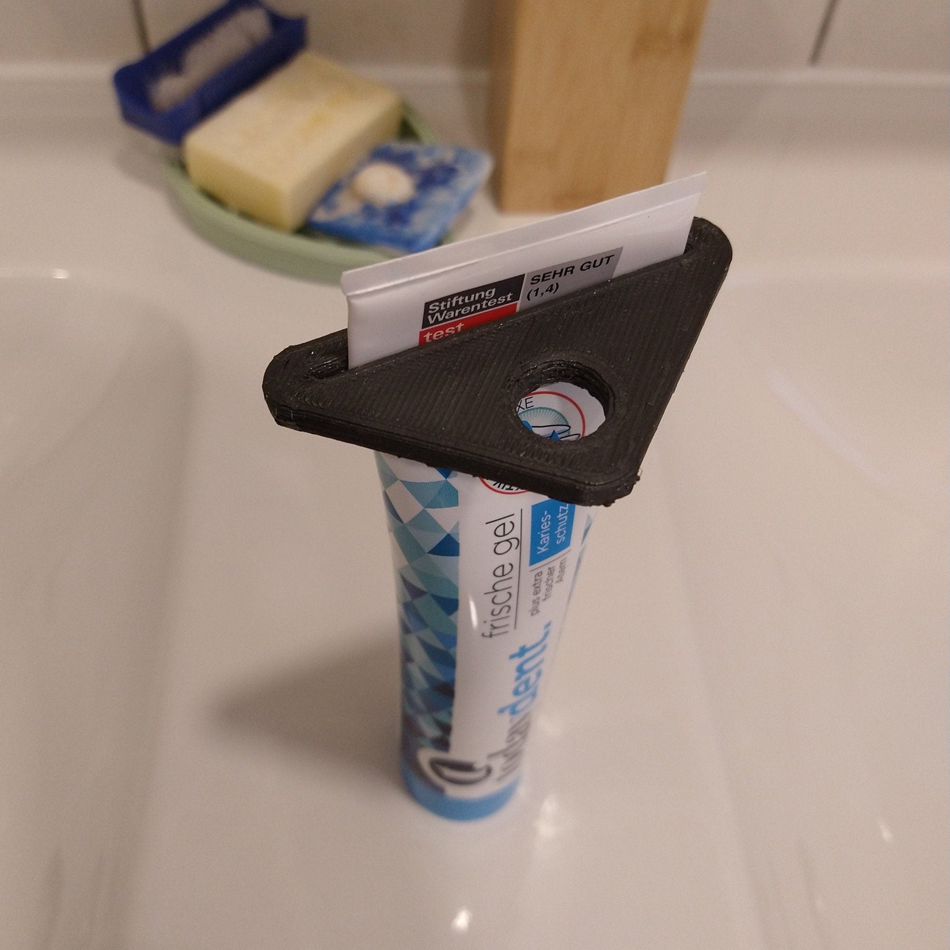 a toothbrush holder with toothpaste and toothpaste on it