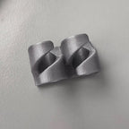 Adhesive cable clips holding USB and charging cords along a desk edge, view 3