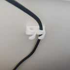 Adhesive cable clips holding USB and charging cords along a desk edge, view 4