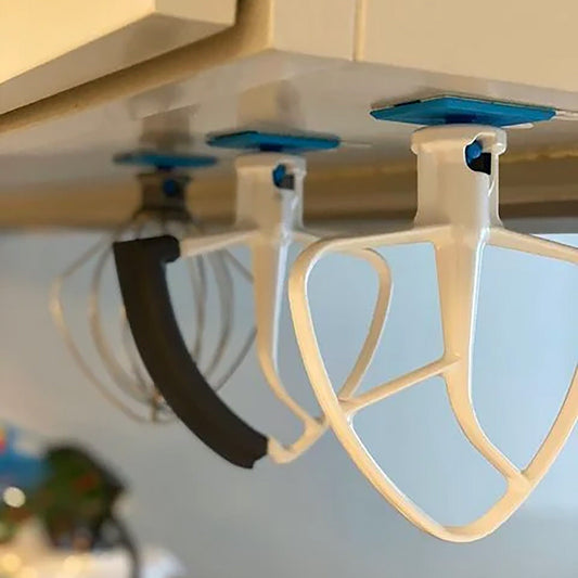 a close up of a bunch of kitchen utensils hanging from a ceiling