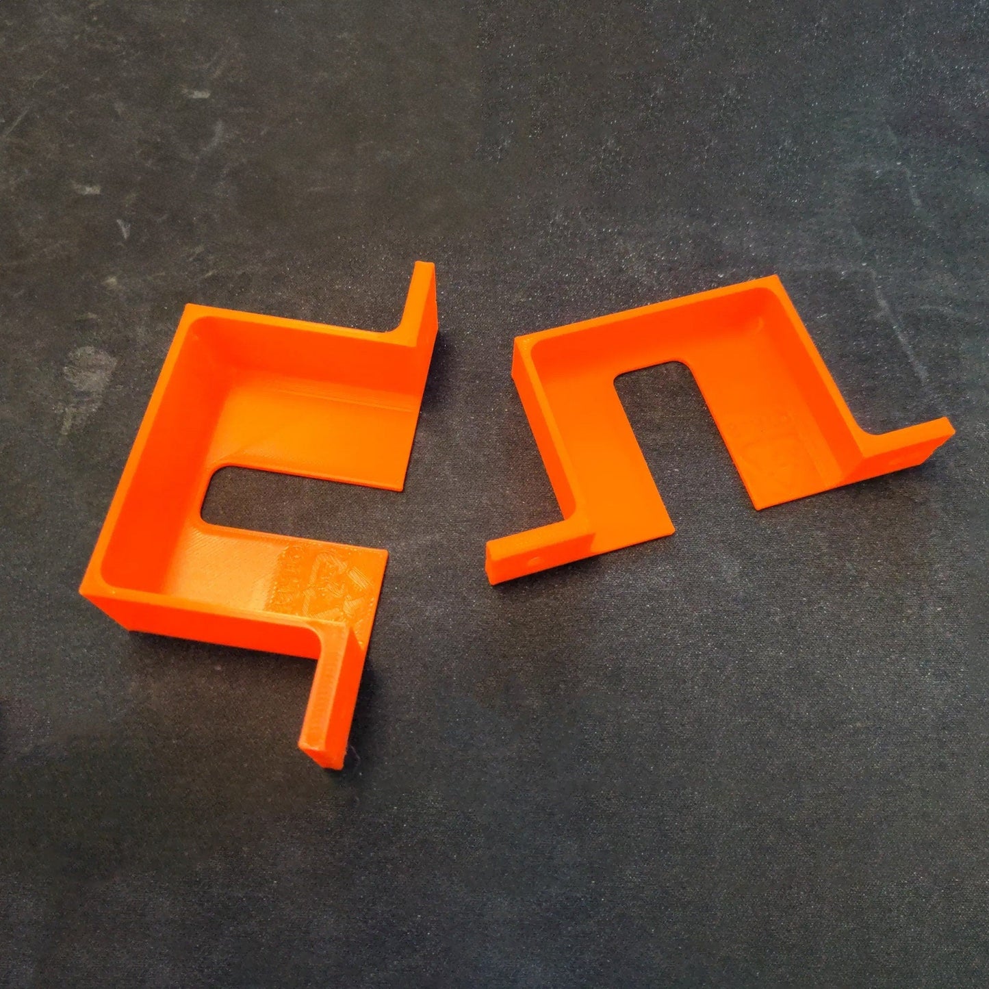 two orange plastic objects sitting on a table