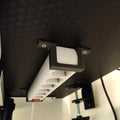 Under desk power strip mount end caps holding a surge protector beneath a desk