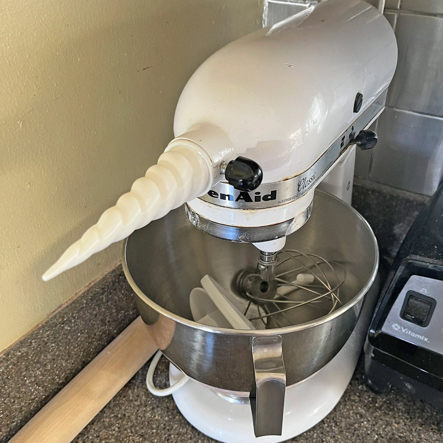 a white mixer sitting on top of a counter