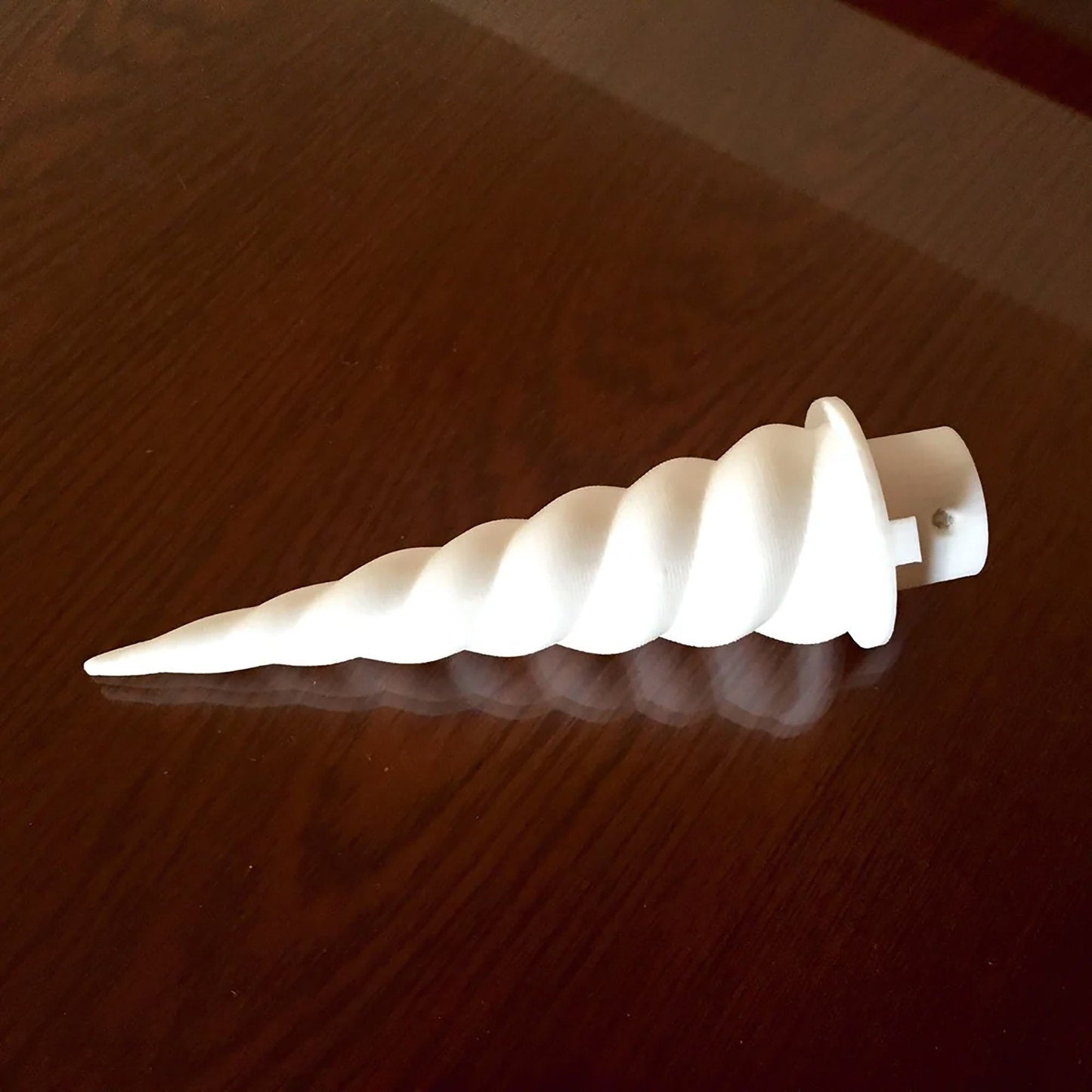 a white object sitting on top of a wooden table