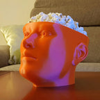 Human head popcorn bowl with an open skull top filled with popcorn, view 4