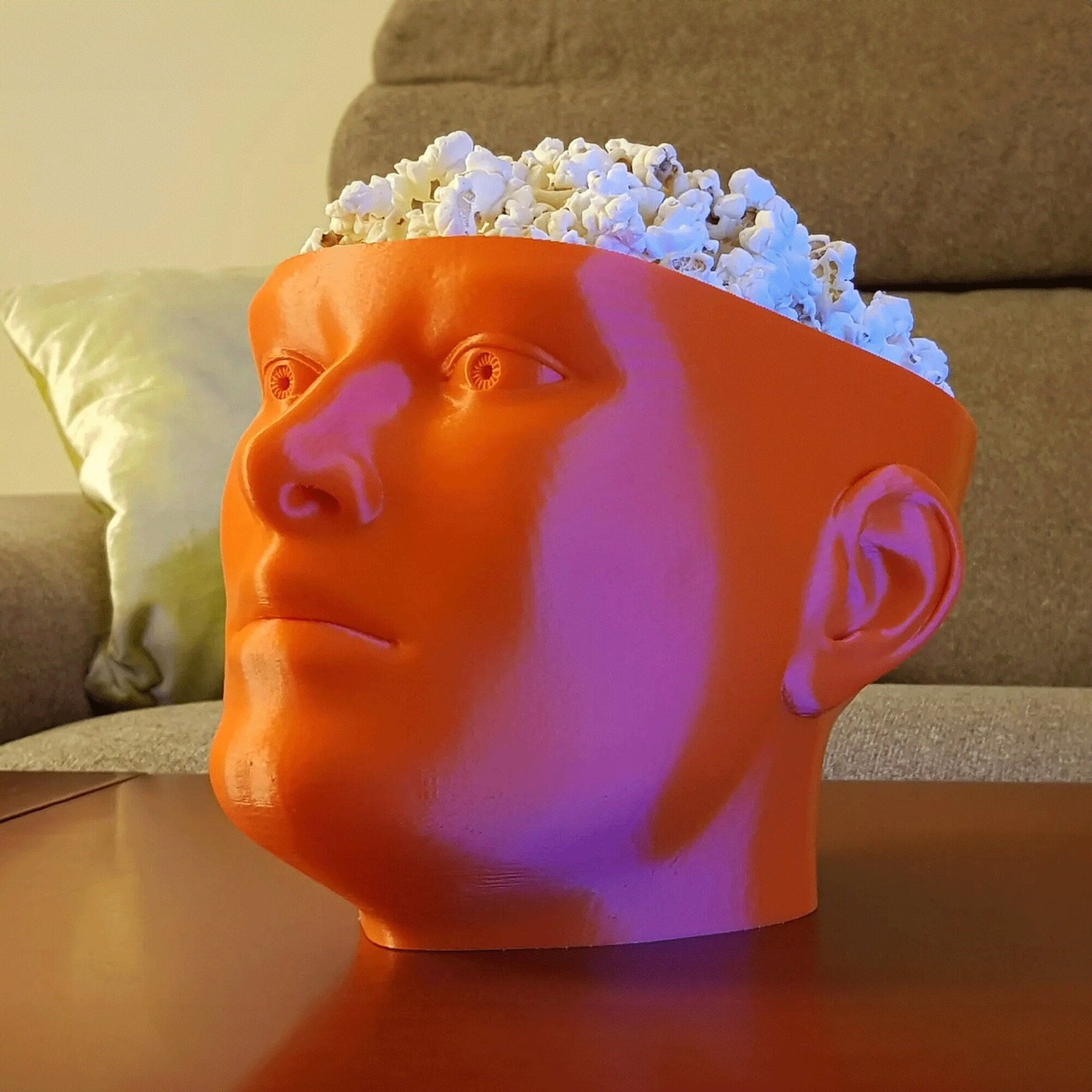 a plastic head with a bunch of popcorn in it