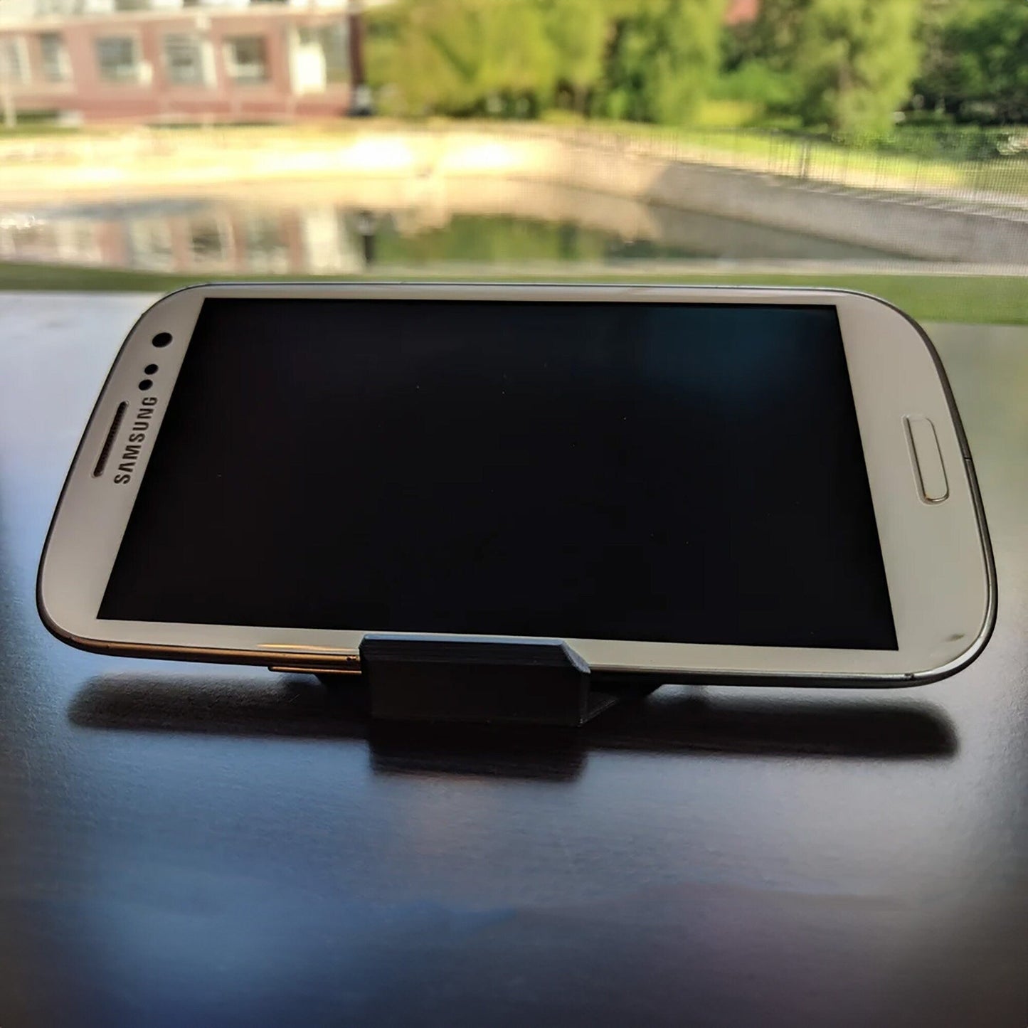 a cell phone sitting on top of a wooden table