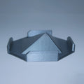 a close up of a metal object on a white surface