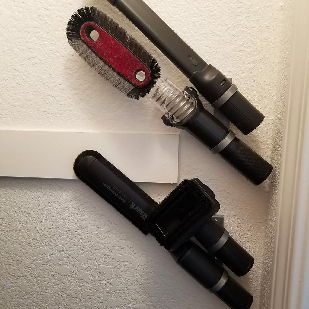 Wall mount holder with two adjustable ring cradles for stick vacuum attachments