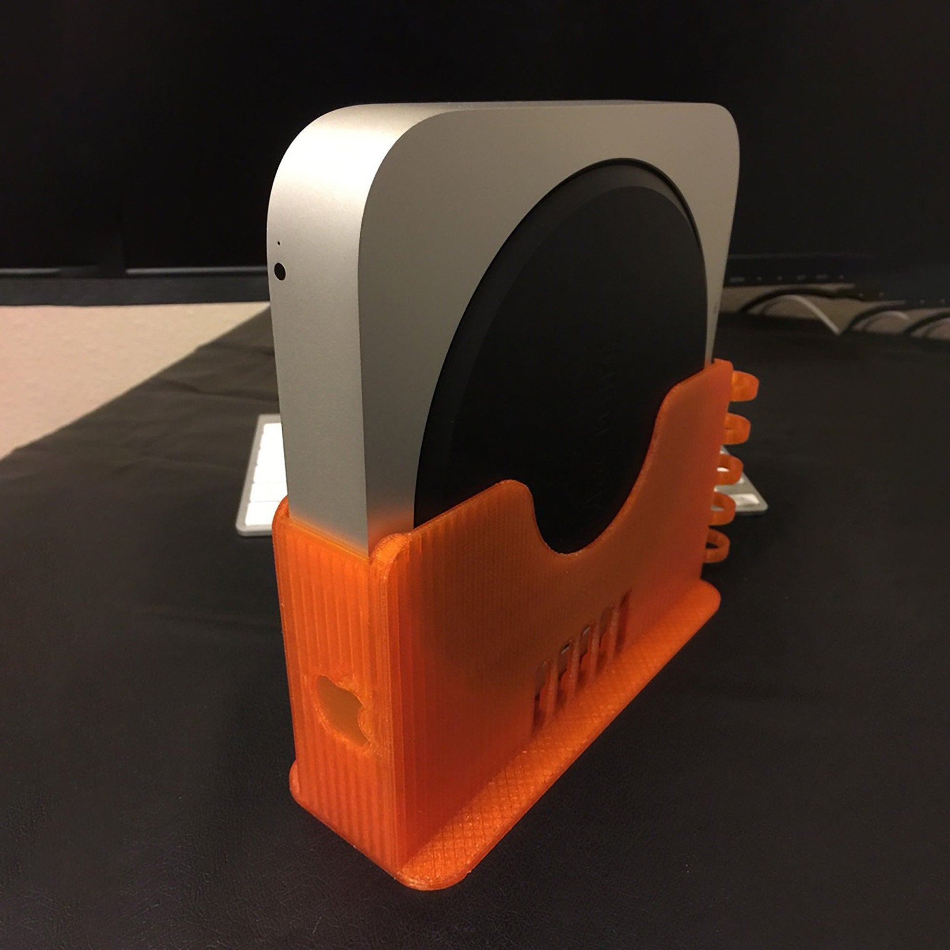 an orange and white device holder on a table