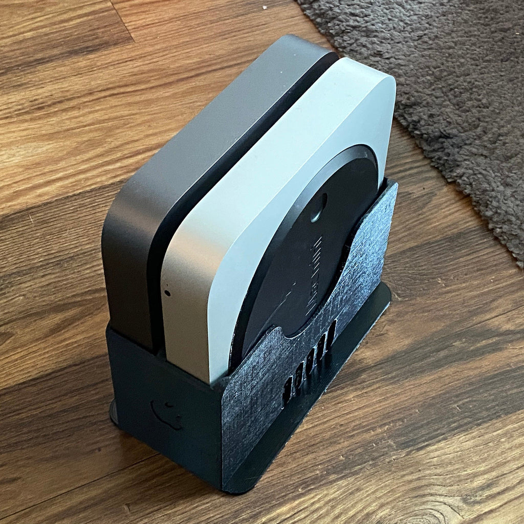 Multi-bay vertical rack holding several Apple Mac Mini units on edge