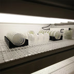 Vertical petri dish rack holding round and square dishes on edge, view 2