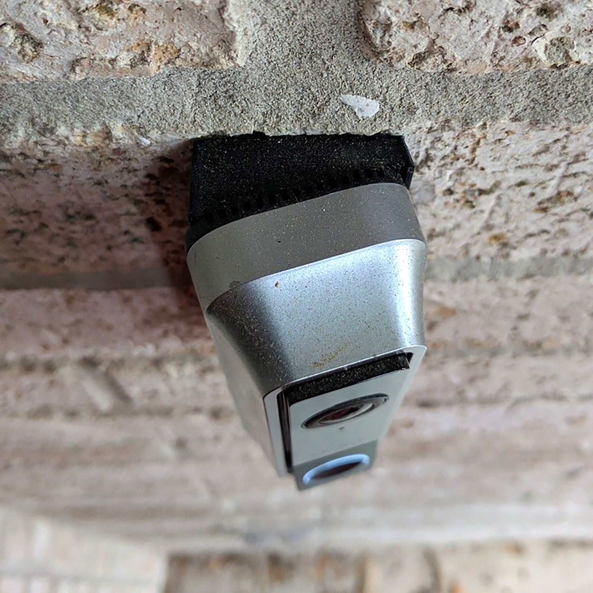 a close up of a camera on a brick wall