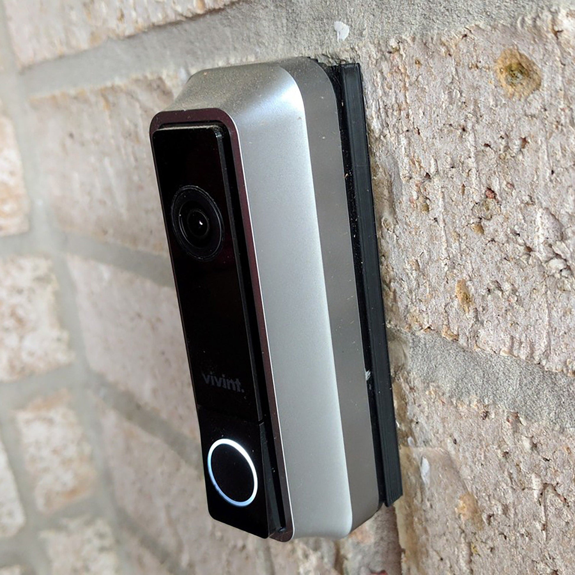 a video camera mounted to a brick wall