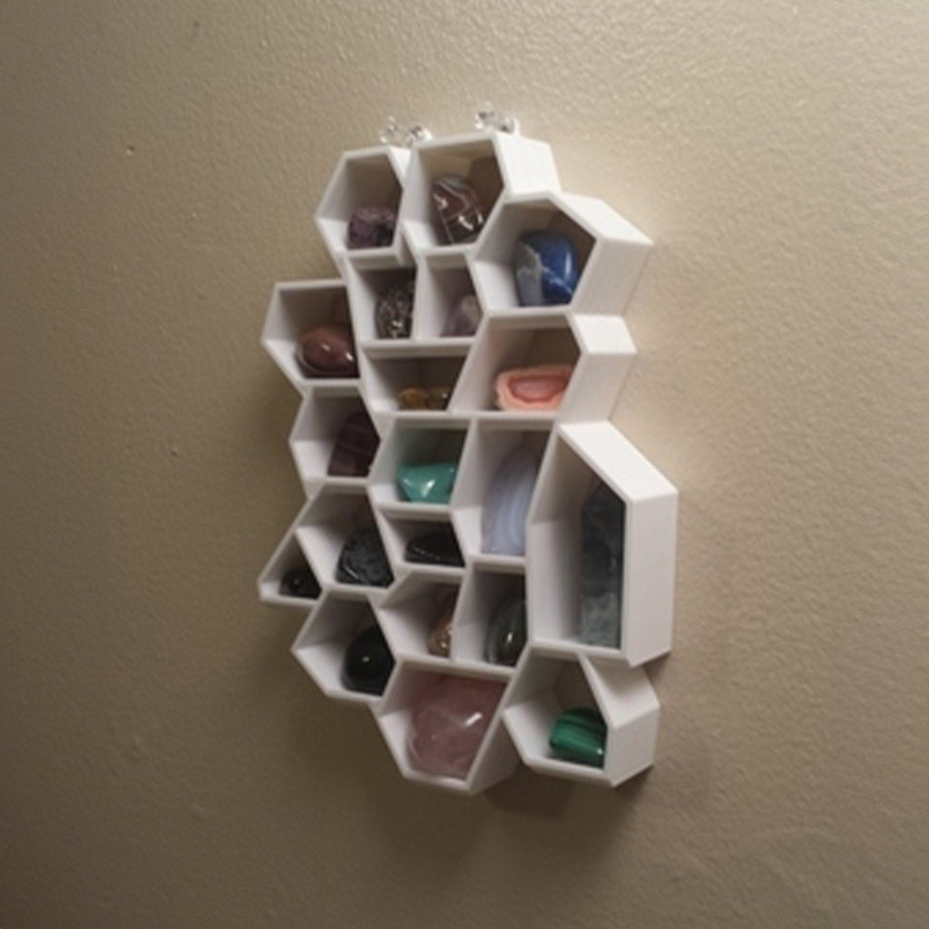 Honeycomb wall shelf displaying crystals and gemstones in hexagonal cells, view 2