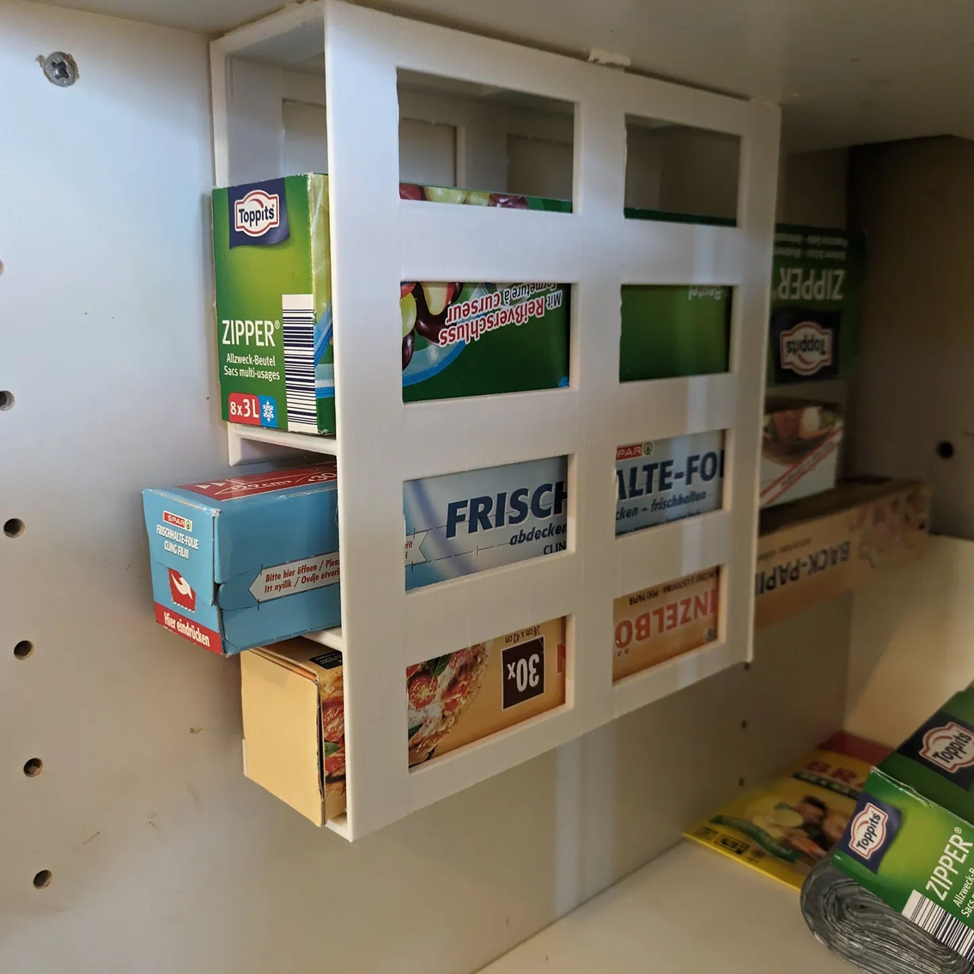 a white shelf filled with lots of boxes of food