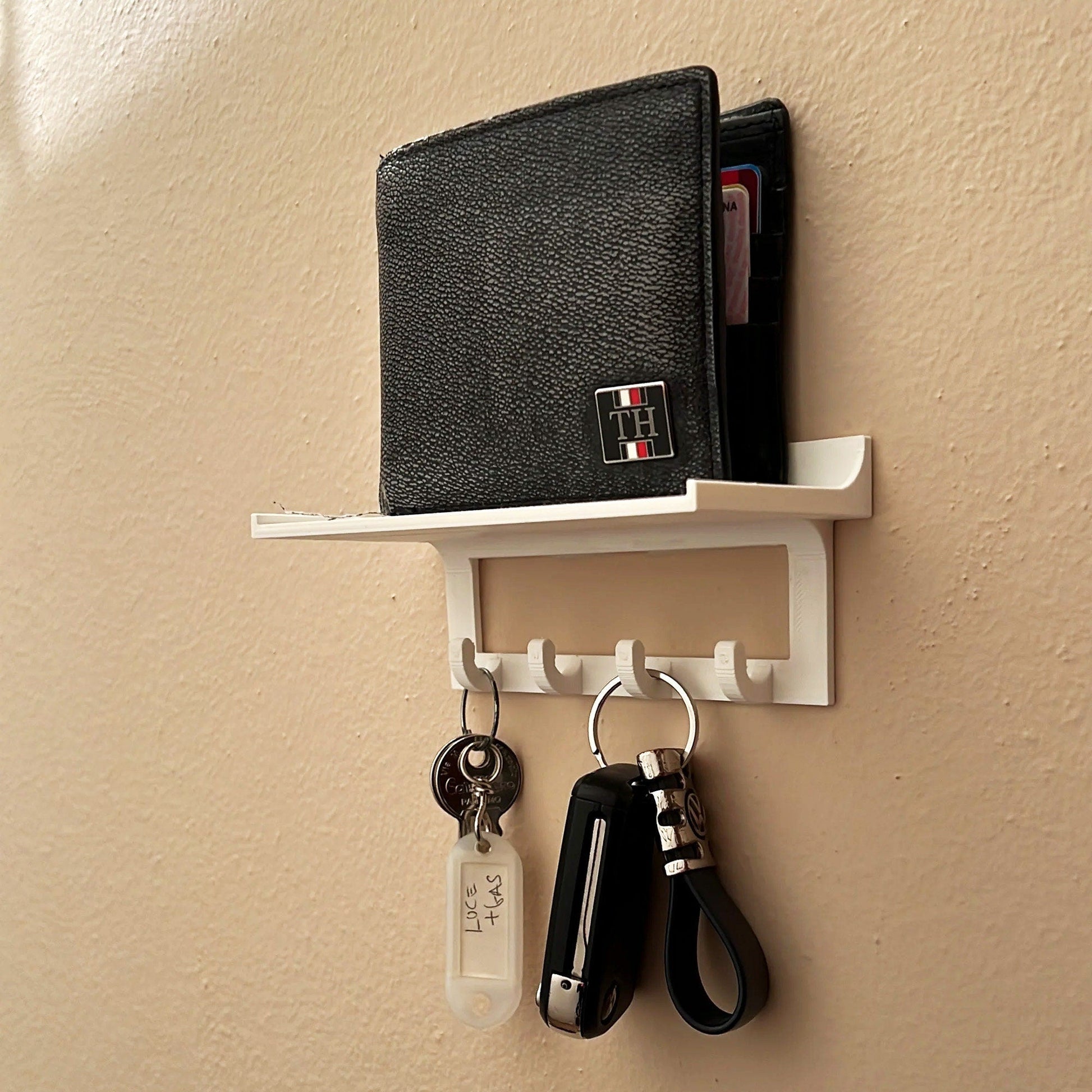 a couple of keys and a wallet hanging on a wall