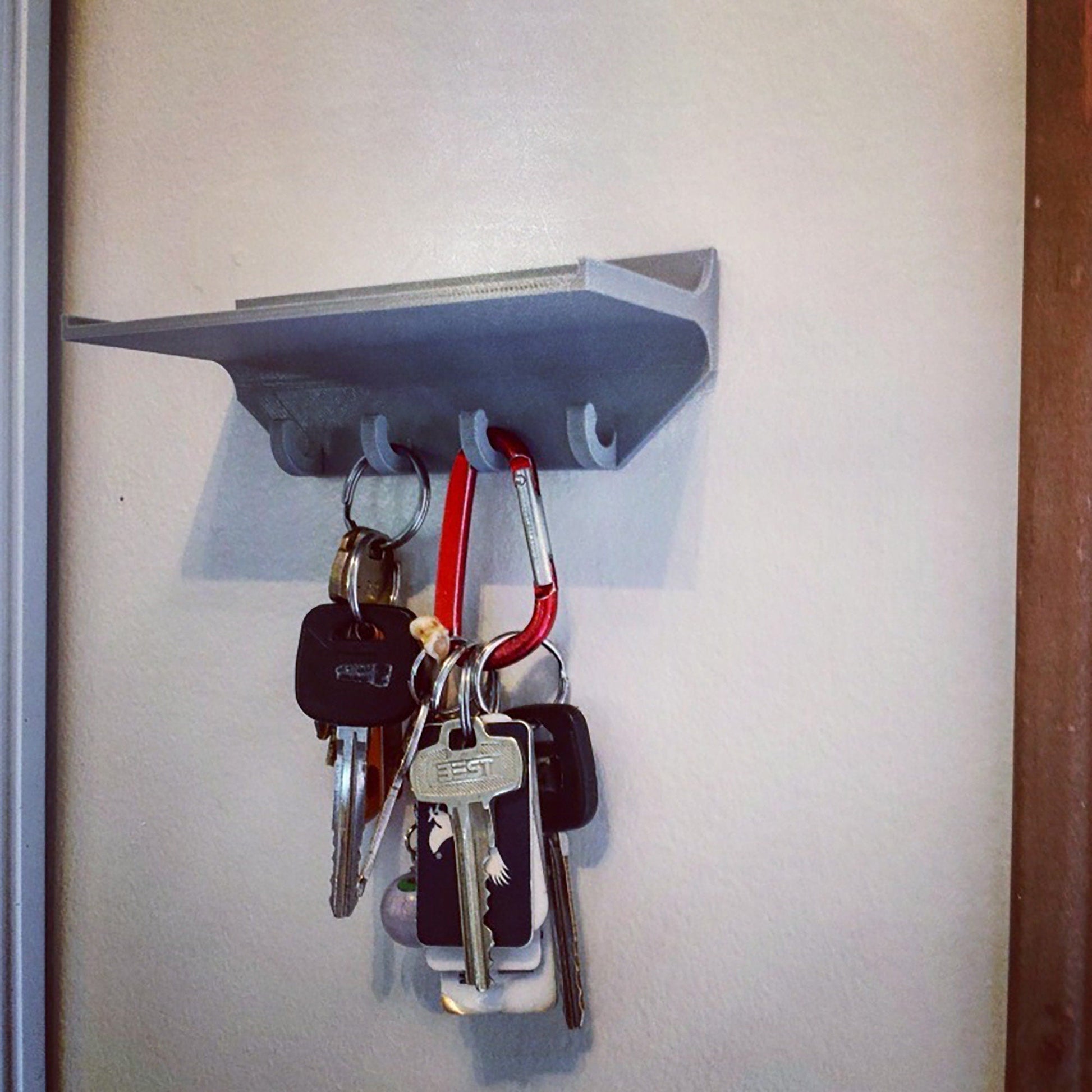 a bunch of keys hanging from a hook on a wall