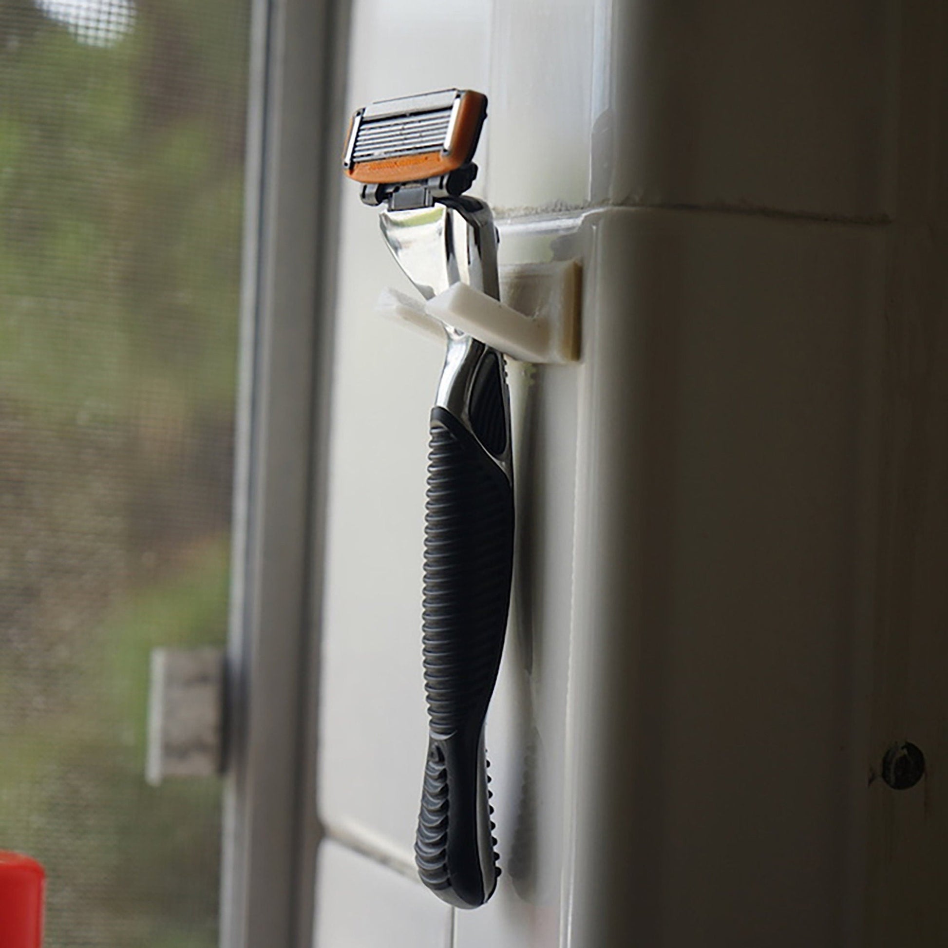 a cell phone hanging from a hook on a wall