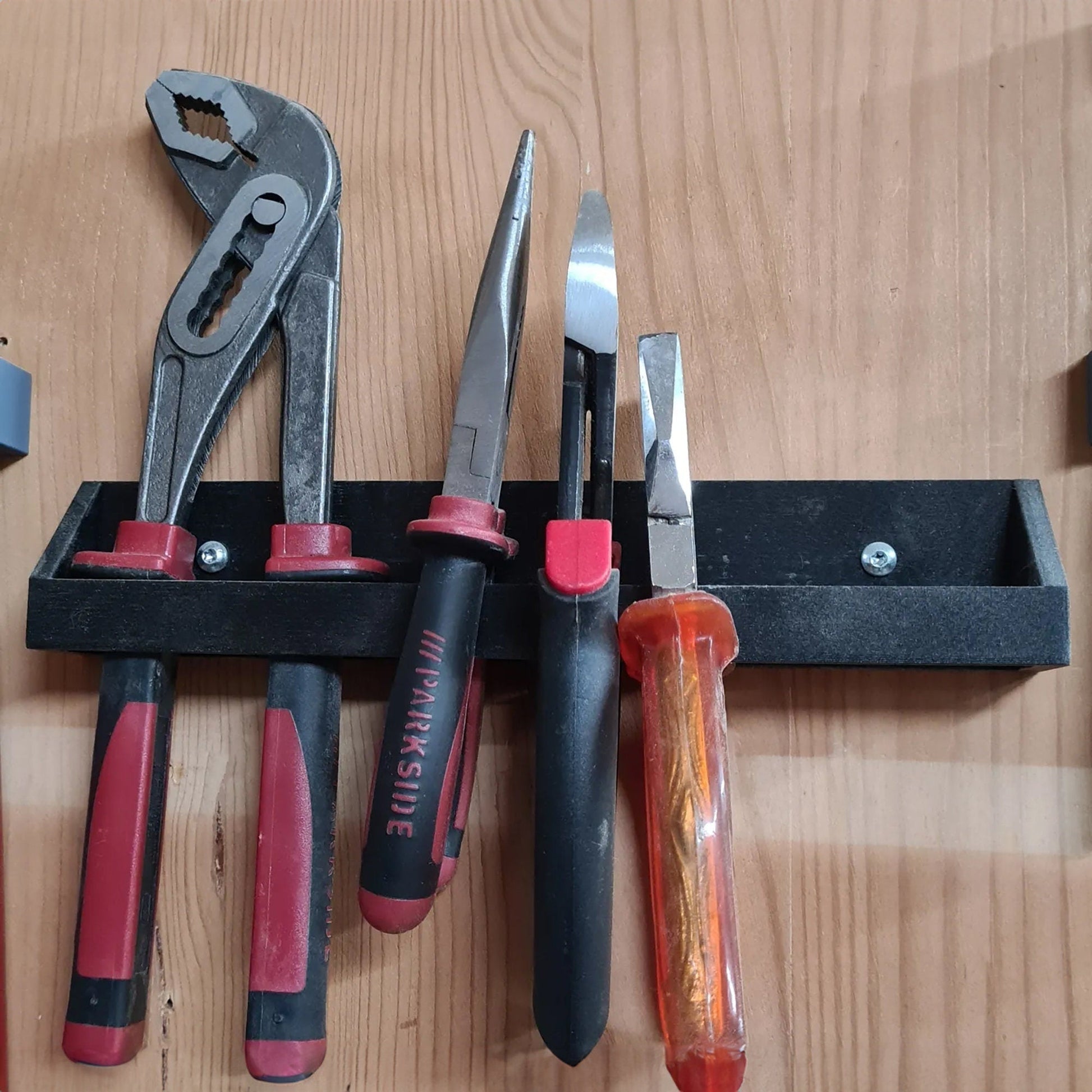 a bunch of tools are hanging on a wall