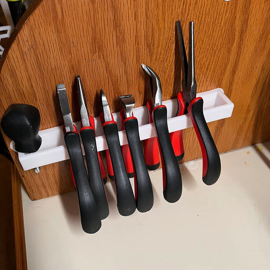 a bunch of tools hanging on a wall