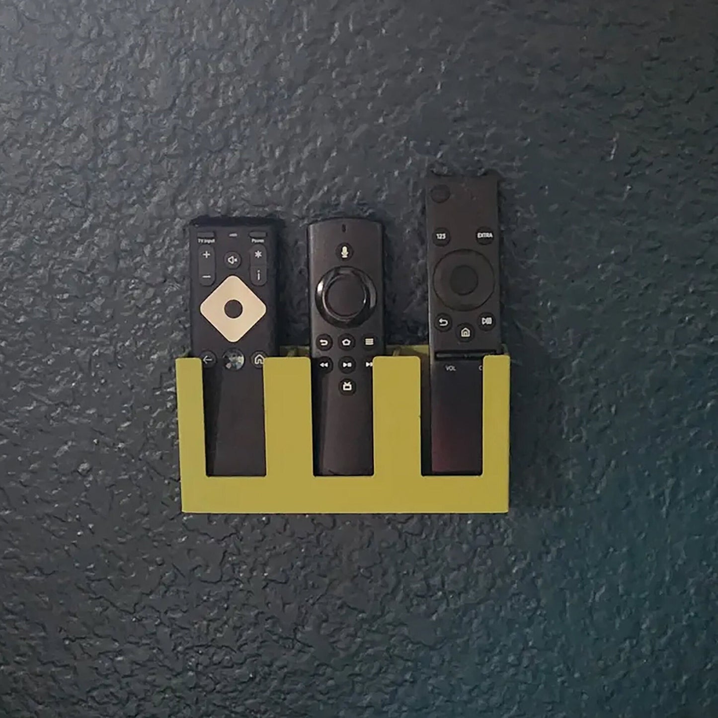 a group of remote controls mounted to a wall