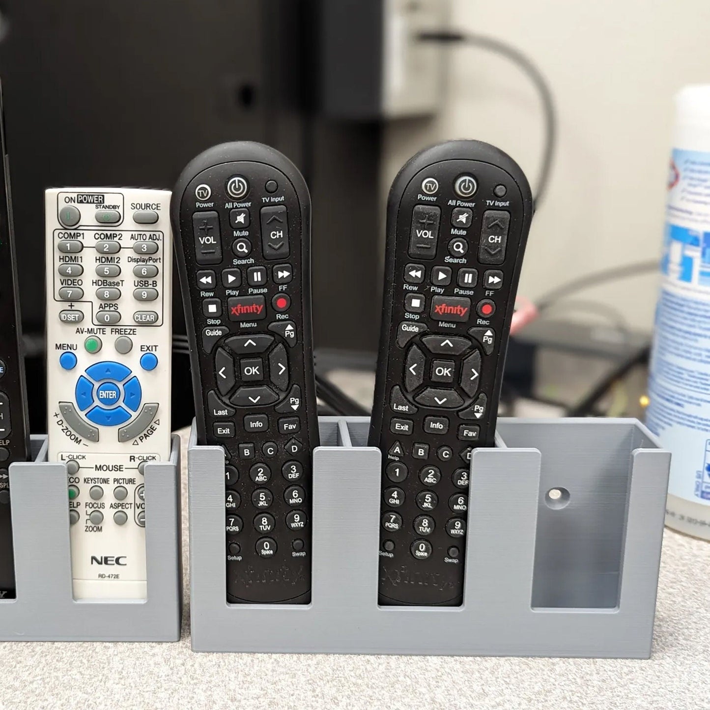 a group of remote controls sitting in a holder