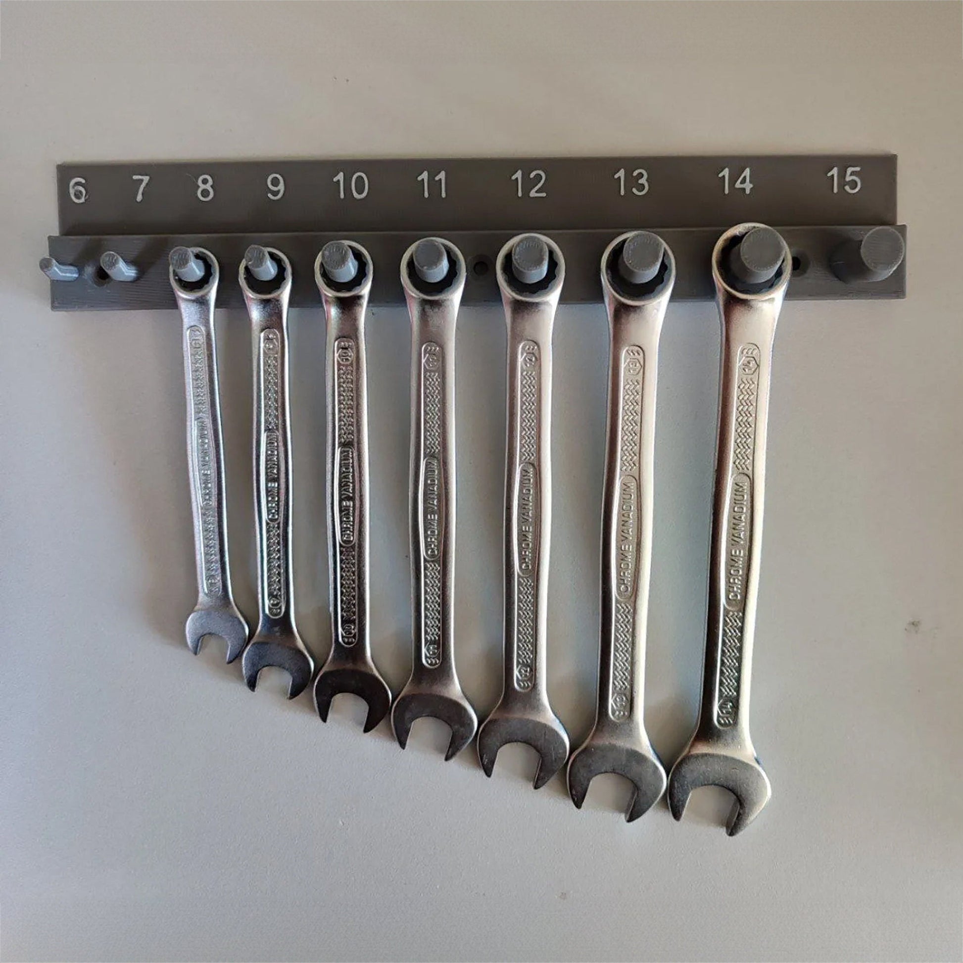 a bunch of wrenches hanging on a wall