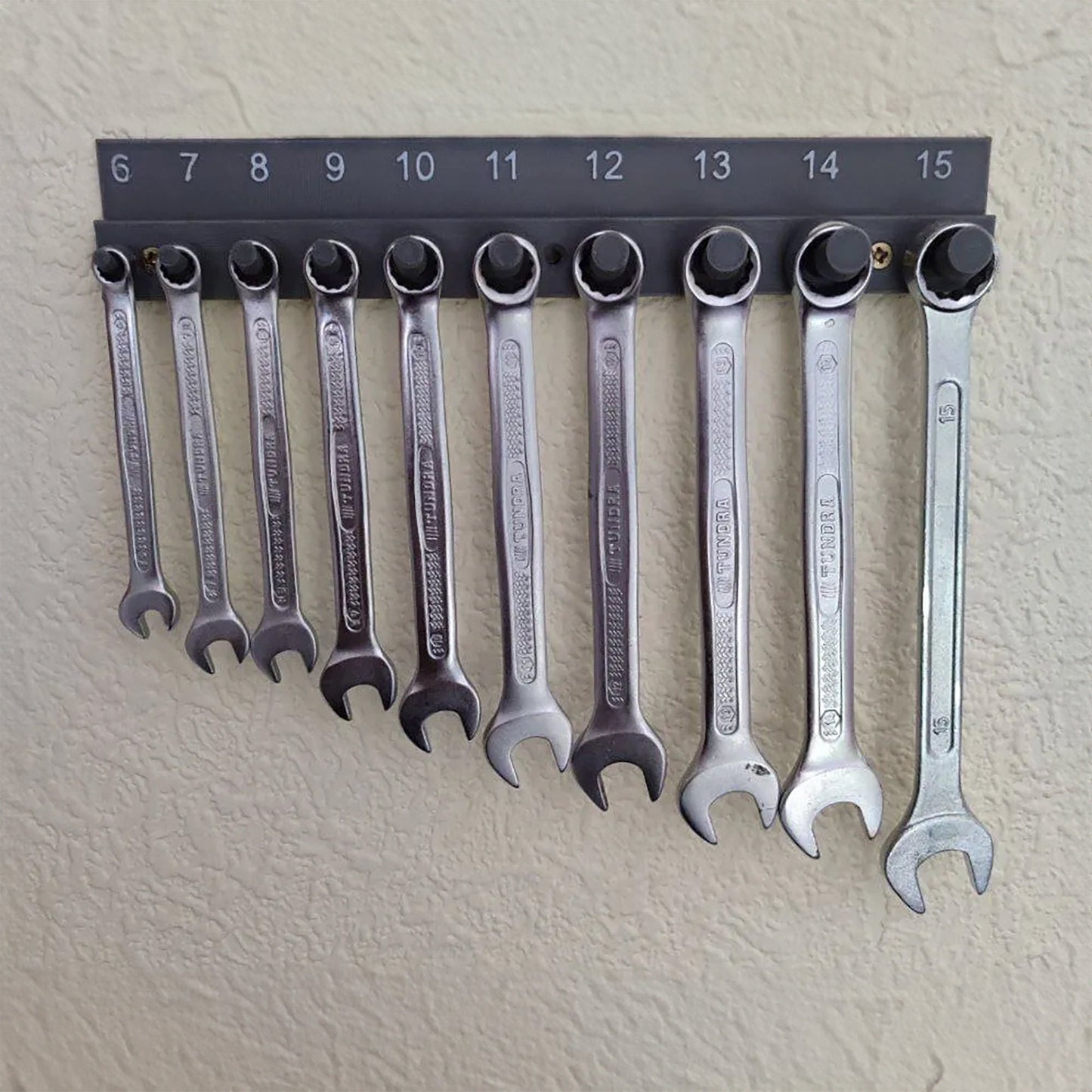 a bunch of wrenches hanging on a wall