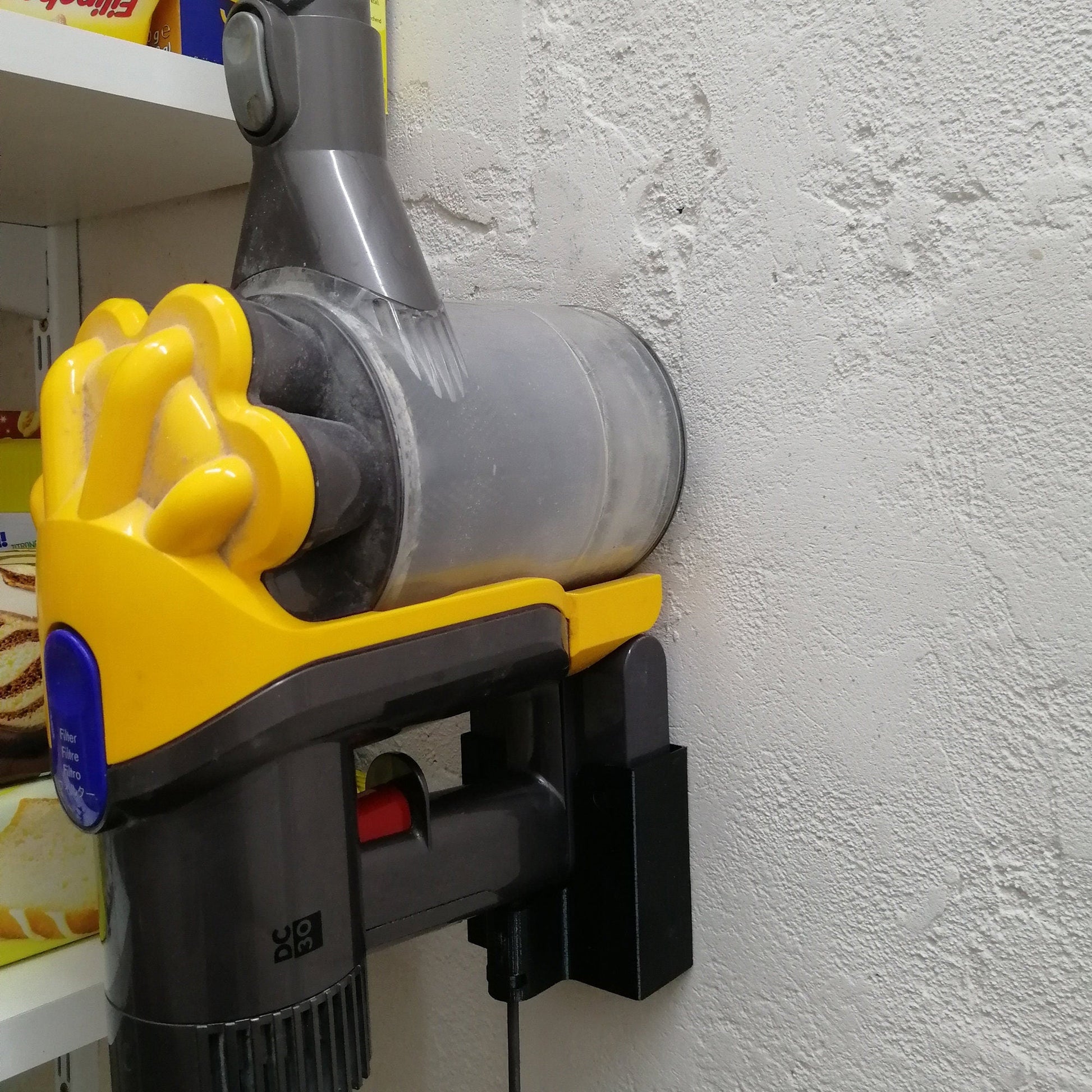 a yellow and black blow dryer mounted to a wall