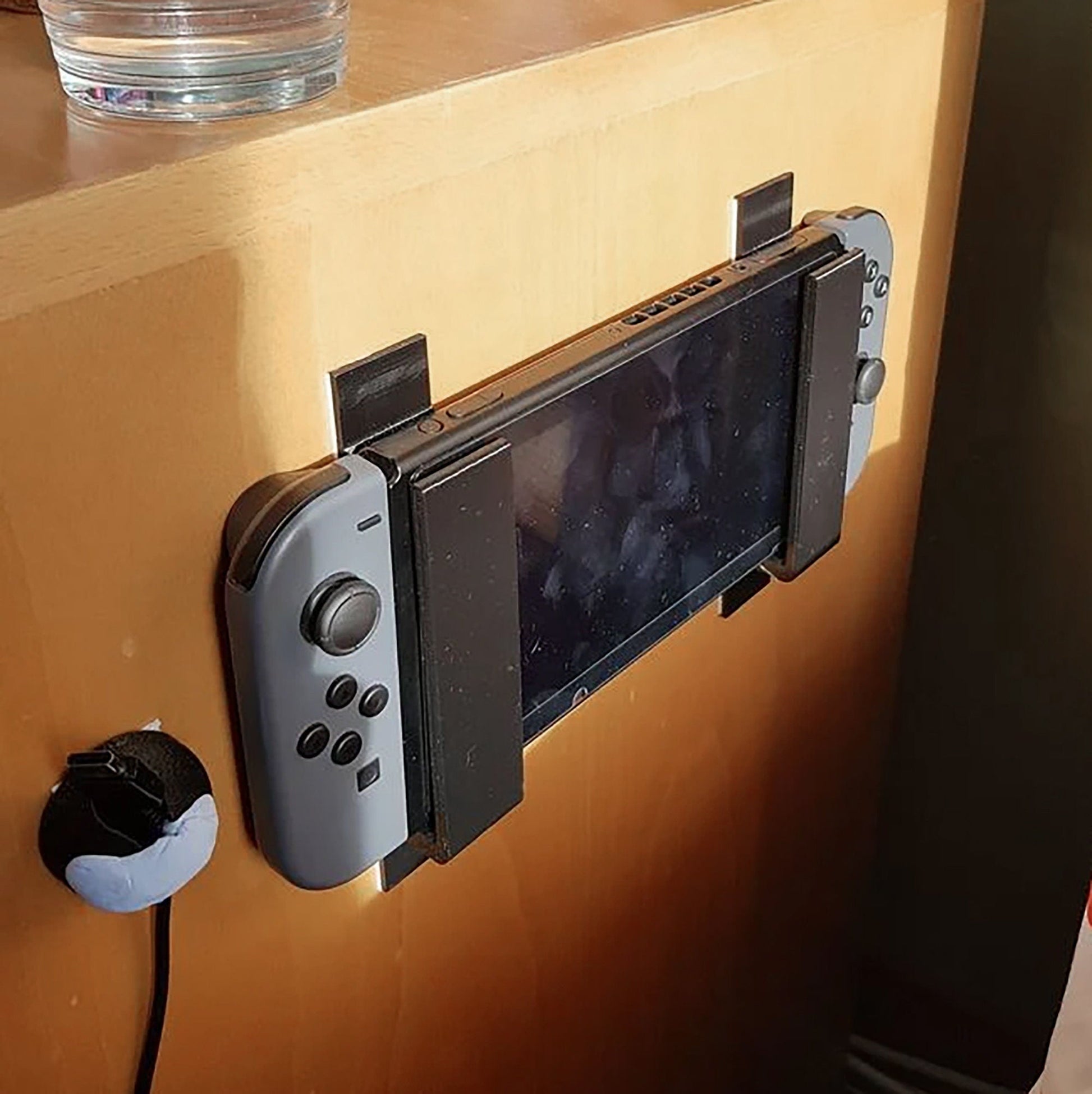 a nintendo wii game controller attached to a wall