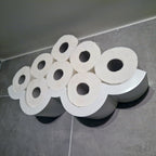 Cloud-shaped wall shelf holding spare toilet paper rolls upright in two rows, view 2