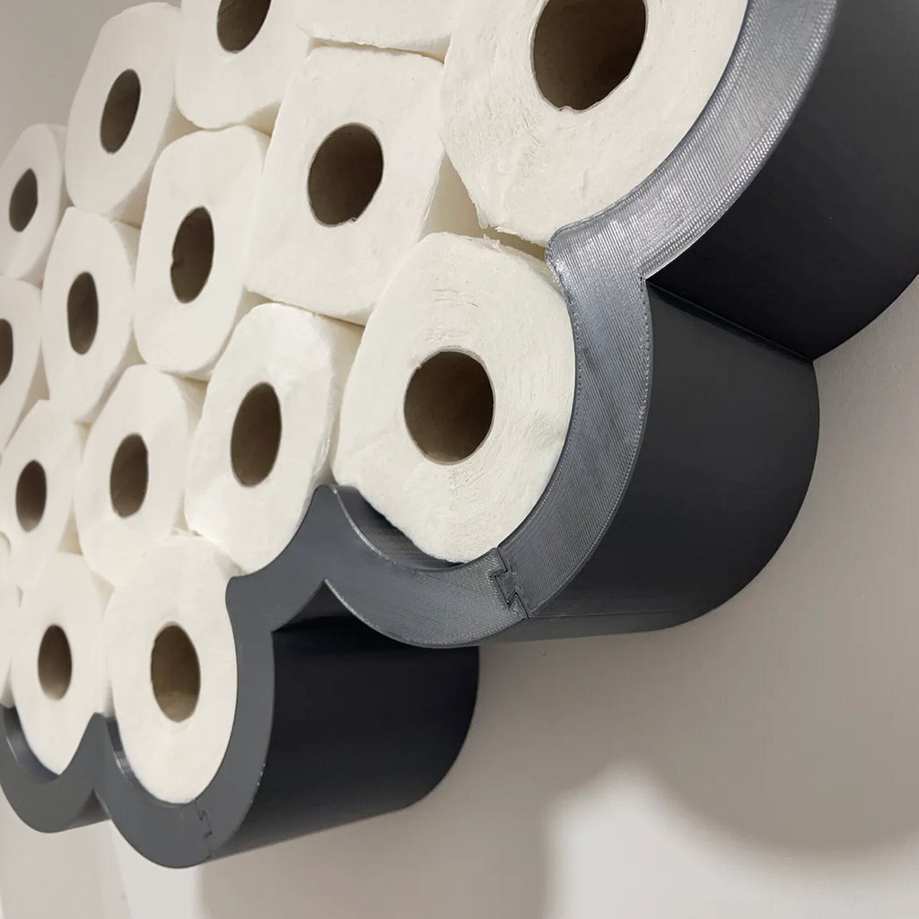 Cloud-shaped wall shelf holding spare toilet paper rolls upright in two rows, view 3