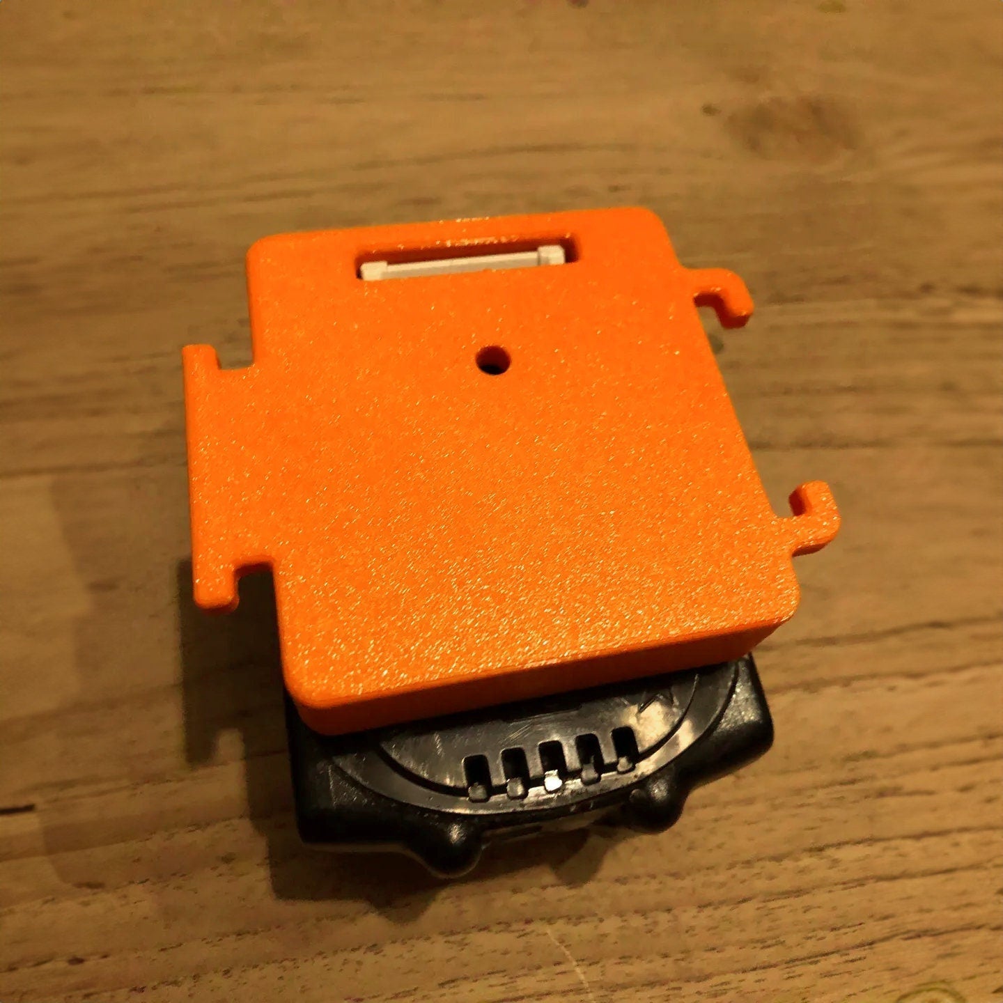 an orange object sitting on top of a wooden table