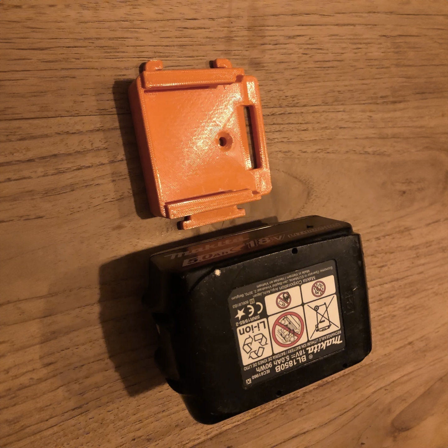 an orange and black box sitting on top of a wooden table