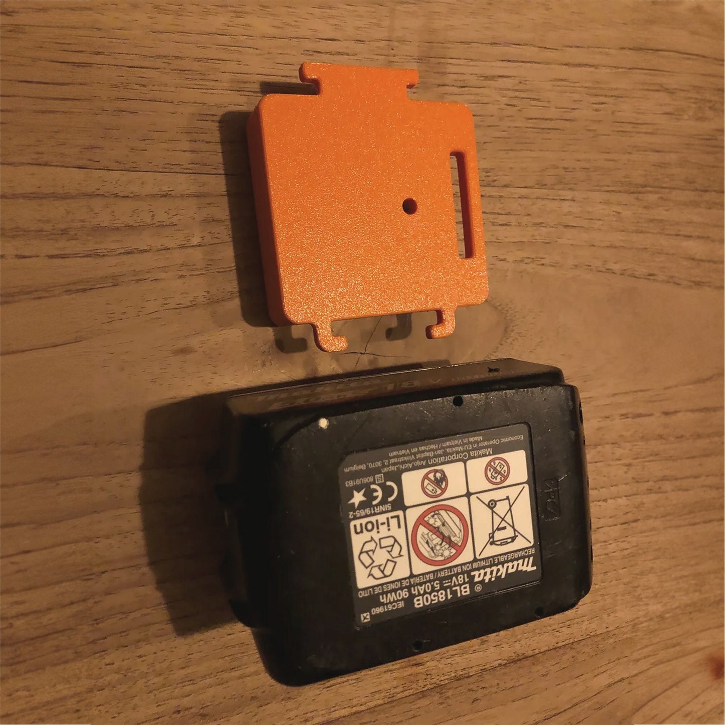 an orange and black device sitting on top of a wooden table