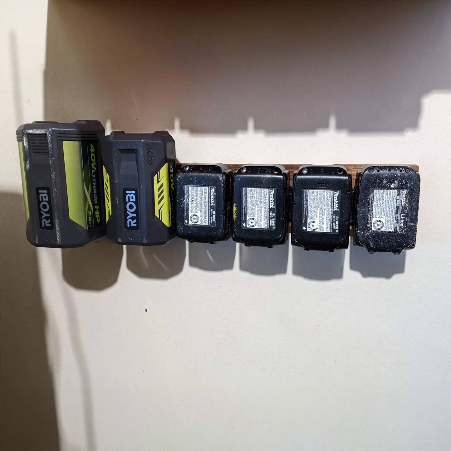 a row of ink cartridges sitting on top of a white wall