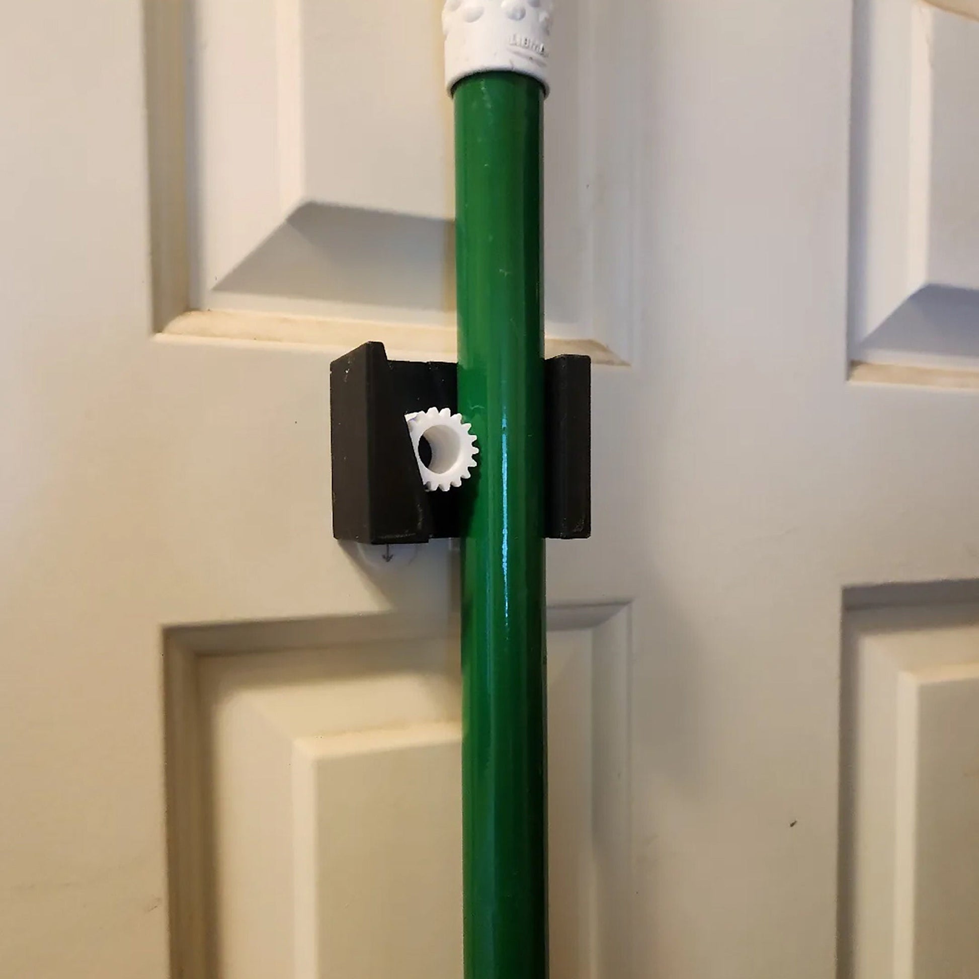 a close up of a green pole on a door