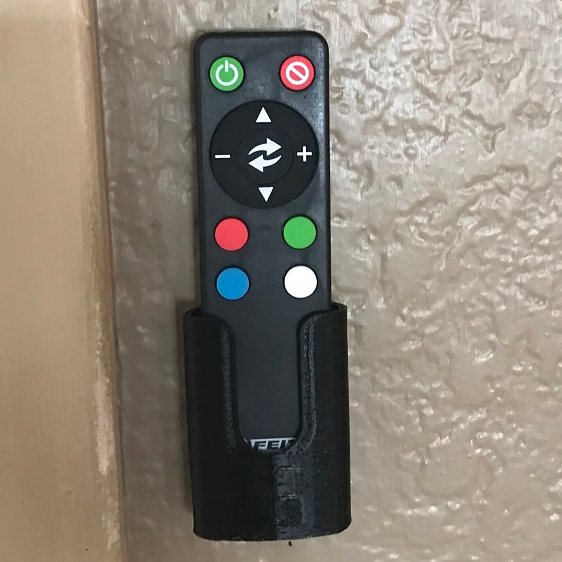 a remote control attached to a wall