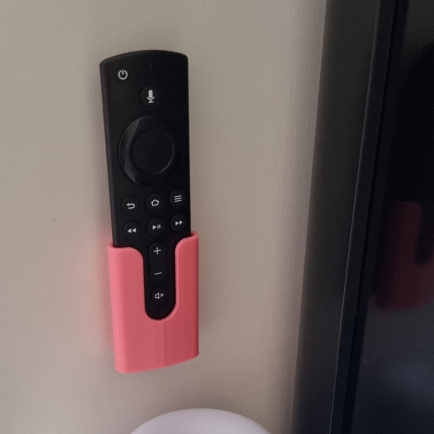 a remote control mounted to the side of a wall