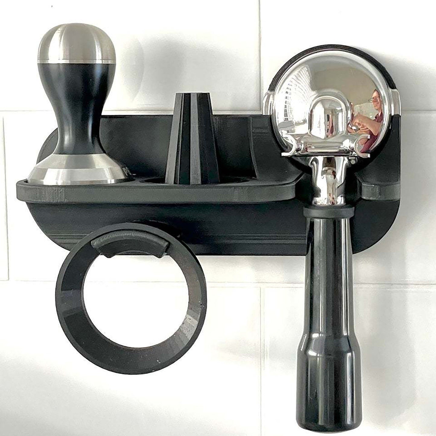 a black wall mounted shelf with a magnifying glass