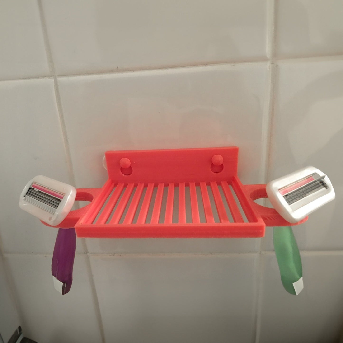 a red shelf with two toothbrushes on it