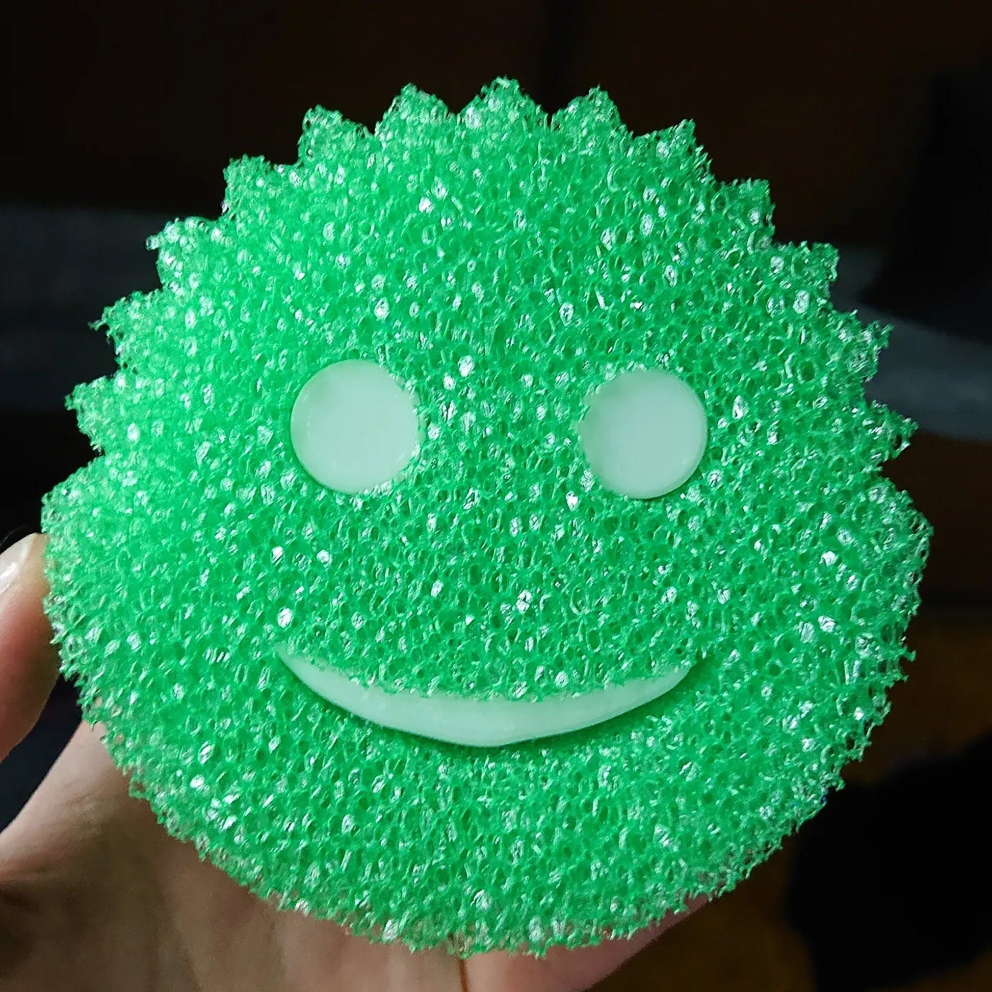 a close up of a person holding a green object