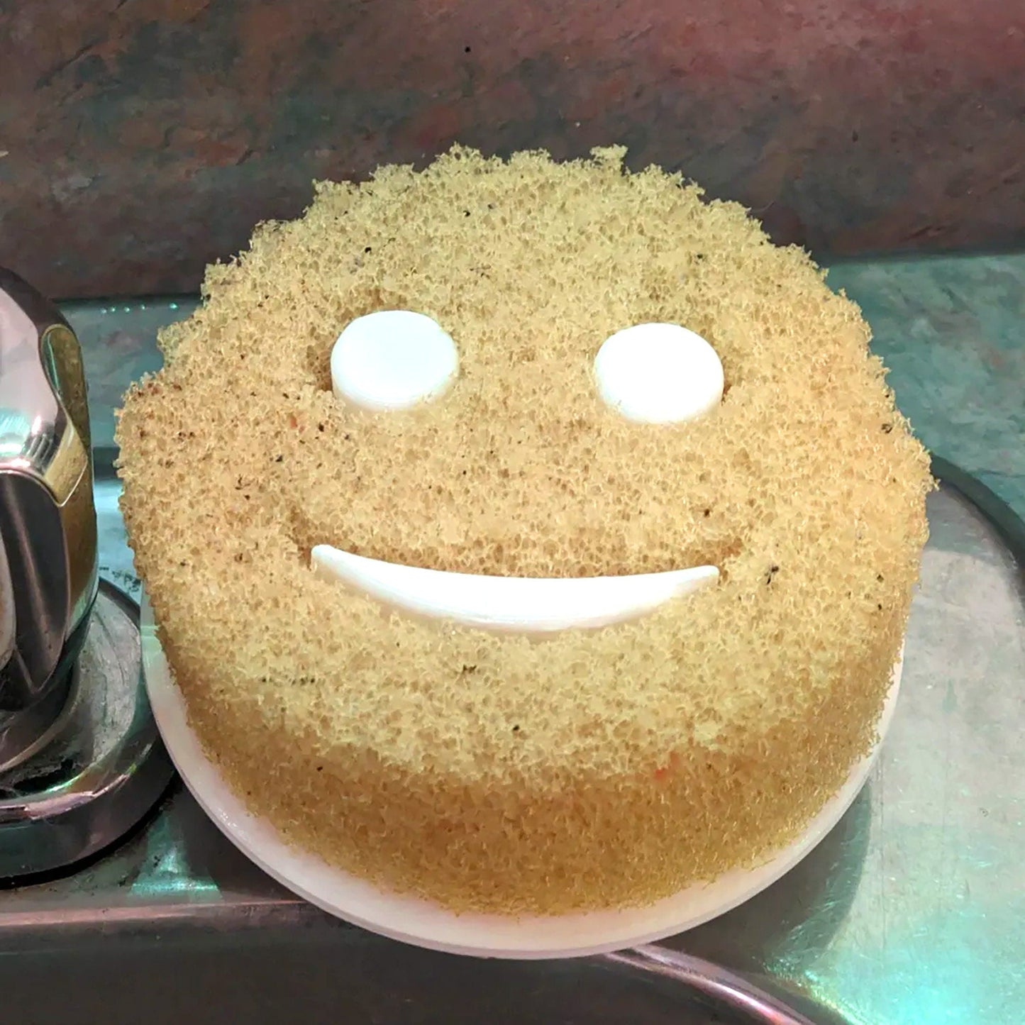 a cake with a smiley face on a plate